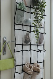 Photo of Organizer with different stuff on door indoors