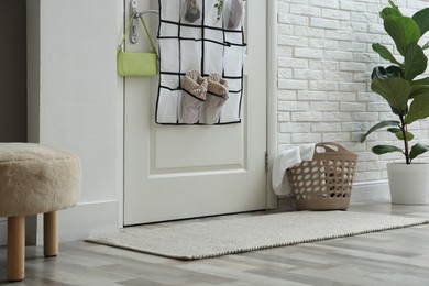 Photo of Organizer with different stuff on door indoors