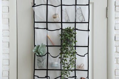 Photo of Organizer with different stuff on door indoors