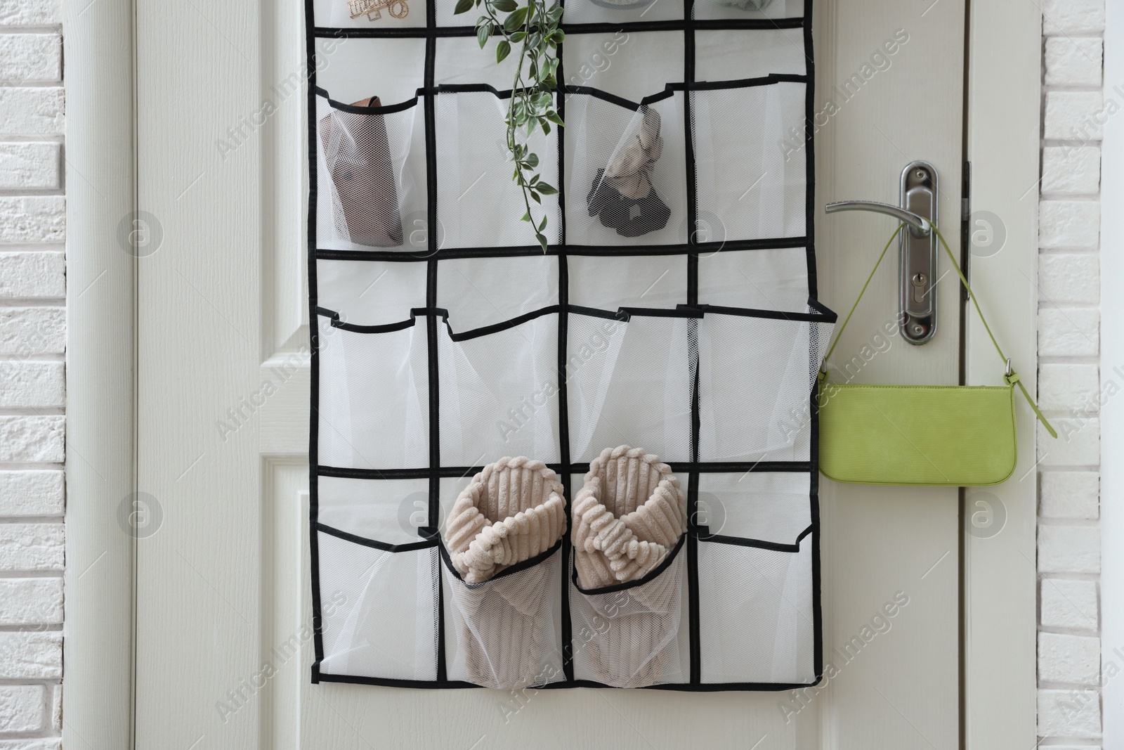 Photo of Organizer with different stuff on door indoors