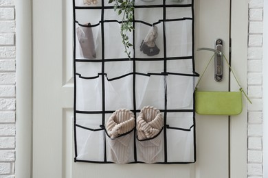 Photo of Organizer with different stuff on door indoors