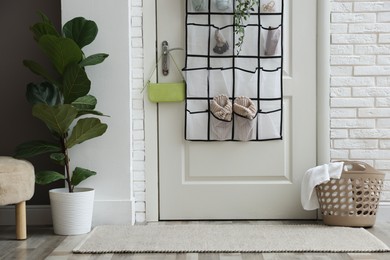 Photo of Organizer with different stuff on door indoors