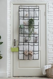 Photo of Organizer with different stuff on door indoors