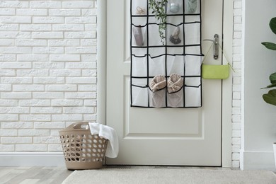 Photo of Organizer with different stuff on door indoors