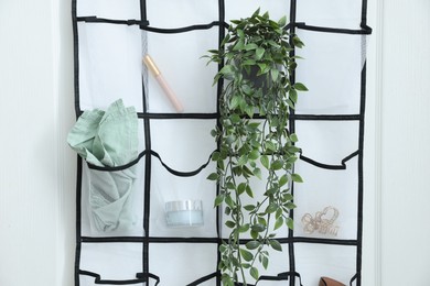 Photo of Organizer with different stuff on door indoors