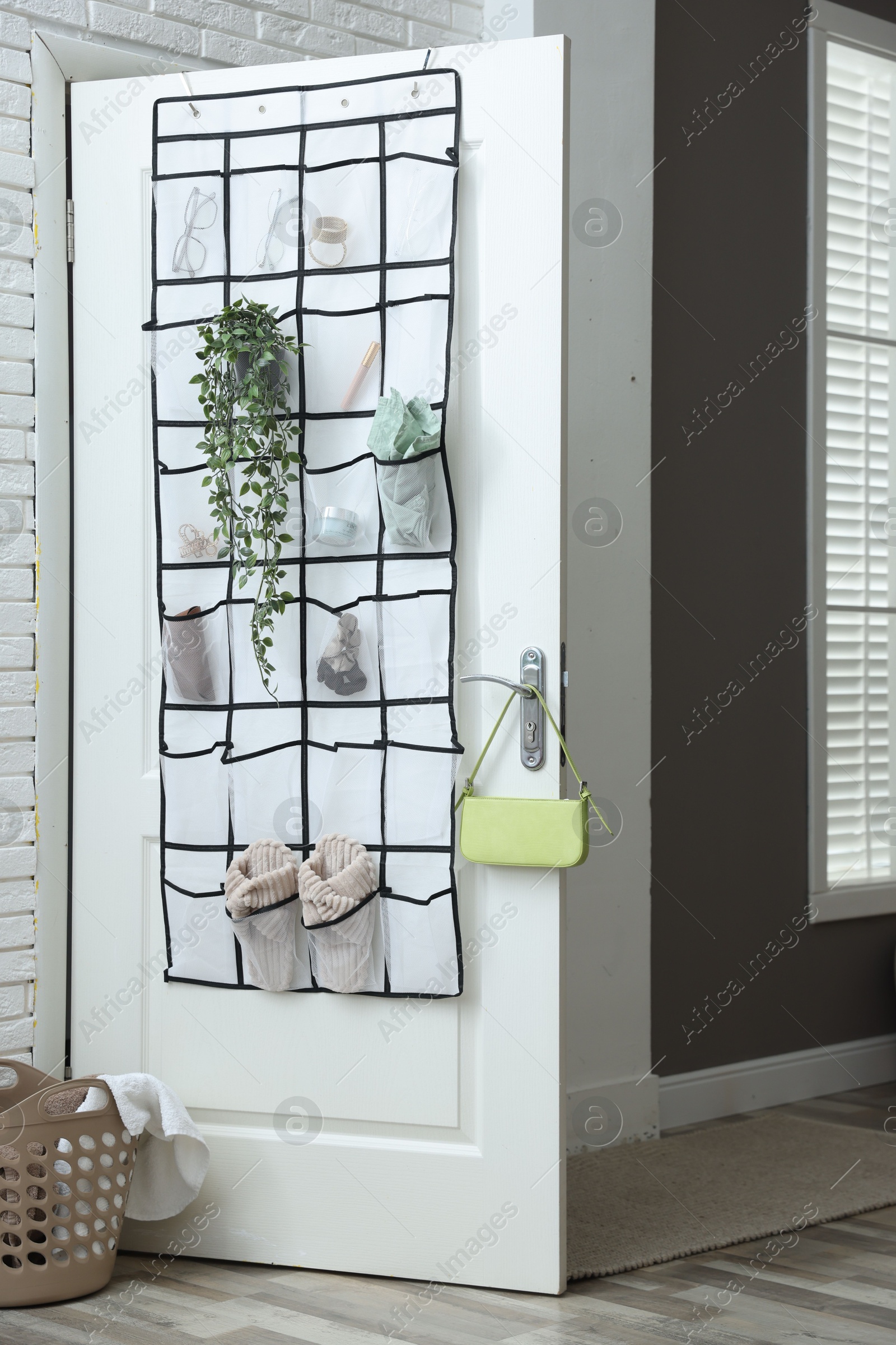 Organizer with different stuff on door indoors Photo of Organizer with different stuff on door indoors