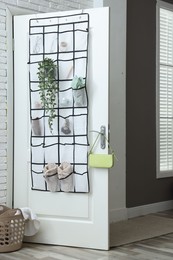 Photo of Organizer with different stuff on door indoors