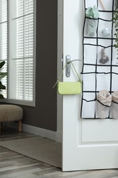 Photo of Organizer with different stuff on door indoors