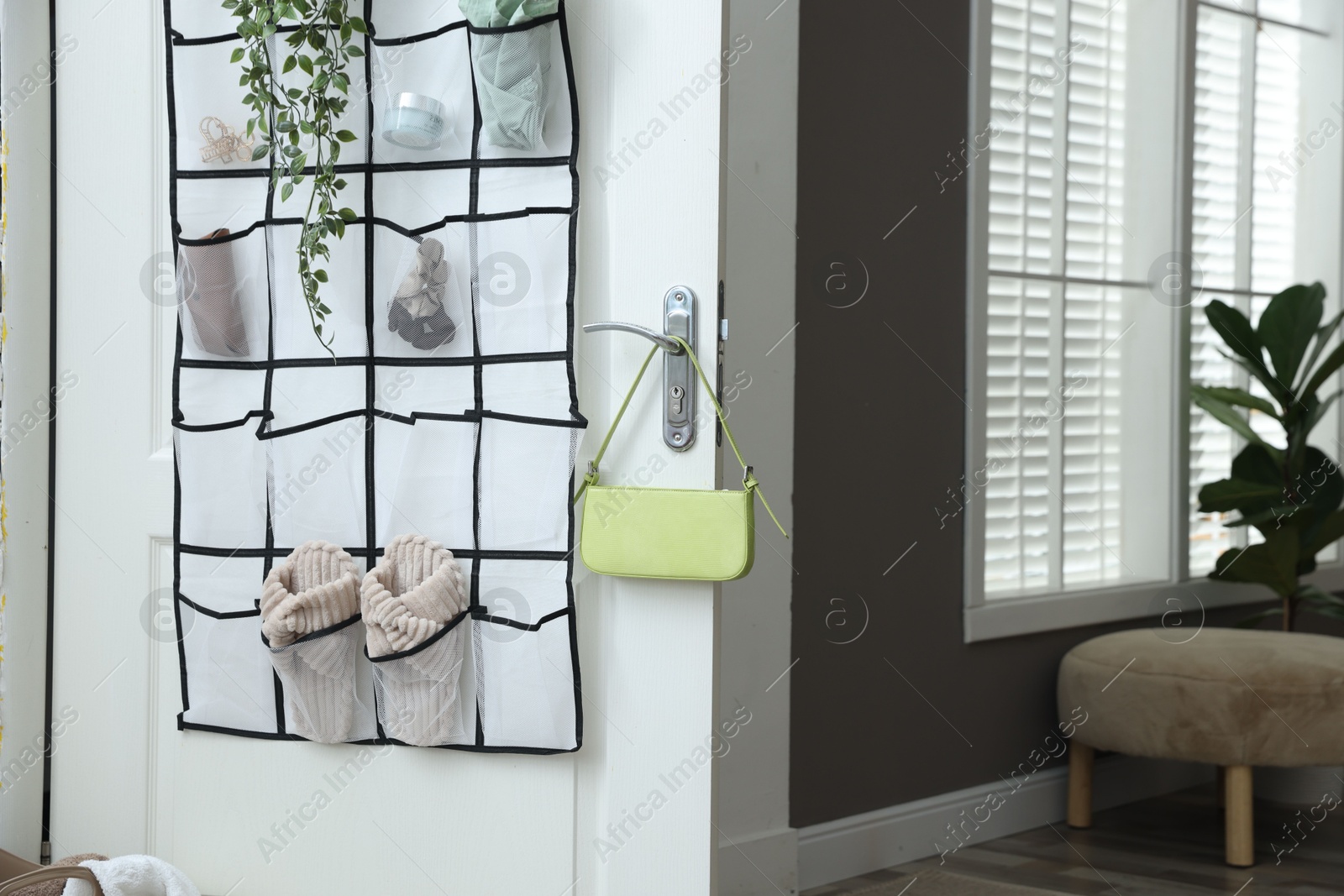 Organizer with different stuff on door indoors Photo of Organizer with different stuff on door indoors