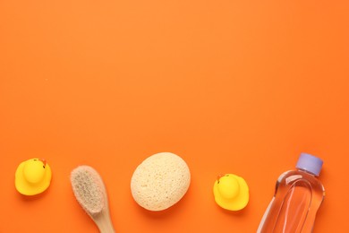 Photo of Baby bath accessories on orange background, flat lay. Space for text