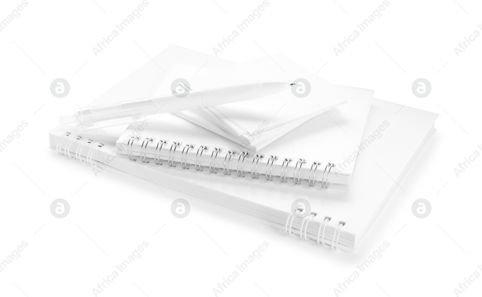 Notebooks, paper notes and pen isolated on white Photo of Notebooks, paper notes and pen isolated on white