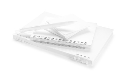 Photo of Notebooks, paper notes and pen isolated on white