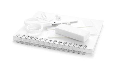 Photo of Notebook and other stationery isolated on white