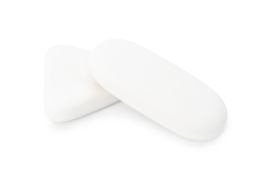 Photo of Two erasers isolated on white. Stationery for school