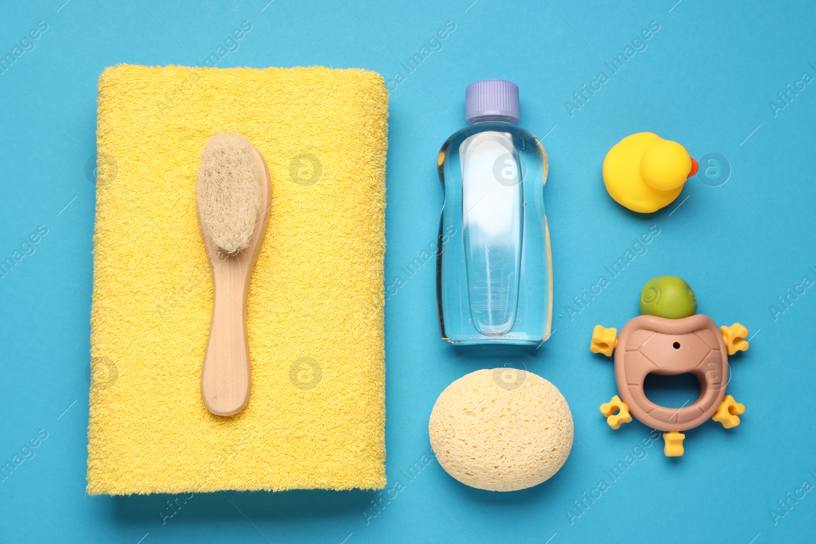 Photo of Baby bath accessories on light blue background, flat lay