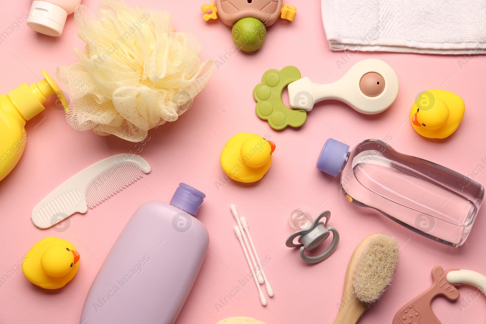 Photo of Baby bath accessories, care products and toys on pink background, flat lay