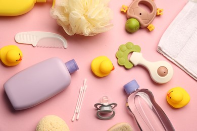 Photo of Baby bath accessories, care products and toys on pink background, flat lay