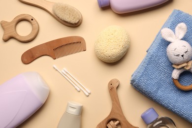 Photo of Baby bath accessories and teethers on beige background, flat lay