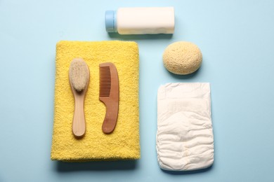 Photo of Baby bath accessories on light blue background, flat lay