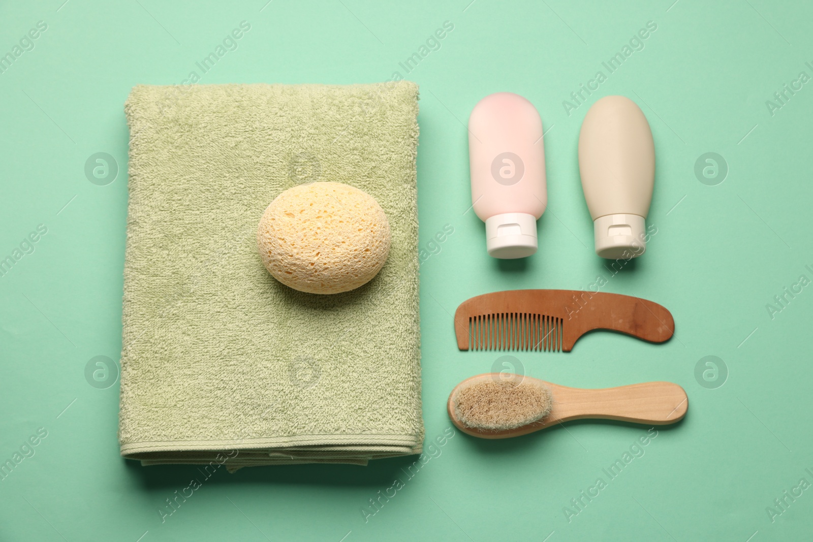 Photo of Baby bath accessories and care products on turquoise background, flat lay