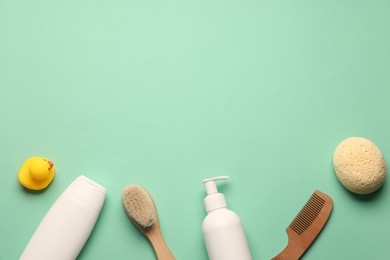 Photo of Baby bath accessories and care products on turquoise background, flat lay. Space for text