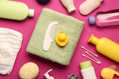 Photo of Baby bath accessories and care products on crimson background, flat lay