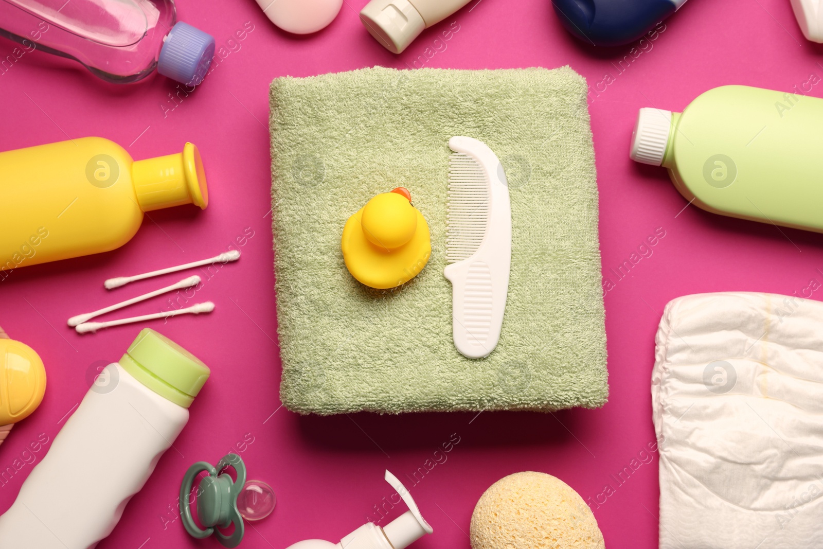 Photo of Baby bath accessories and care products on crimson background, flat lay