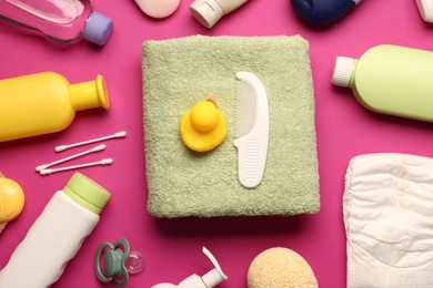 Photo of Baby bath accessories and care products on crimson background, flat lay