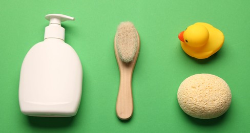 Photo of Baby bath accessories on green background, flat lay
