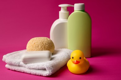 Photo of Baby bath accessories and care products on crimson background, closeup