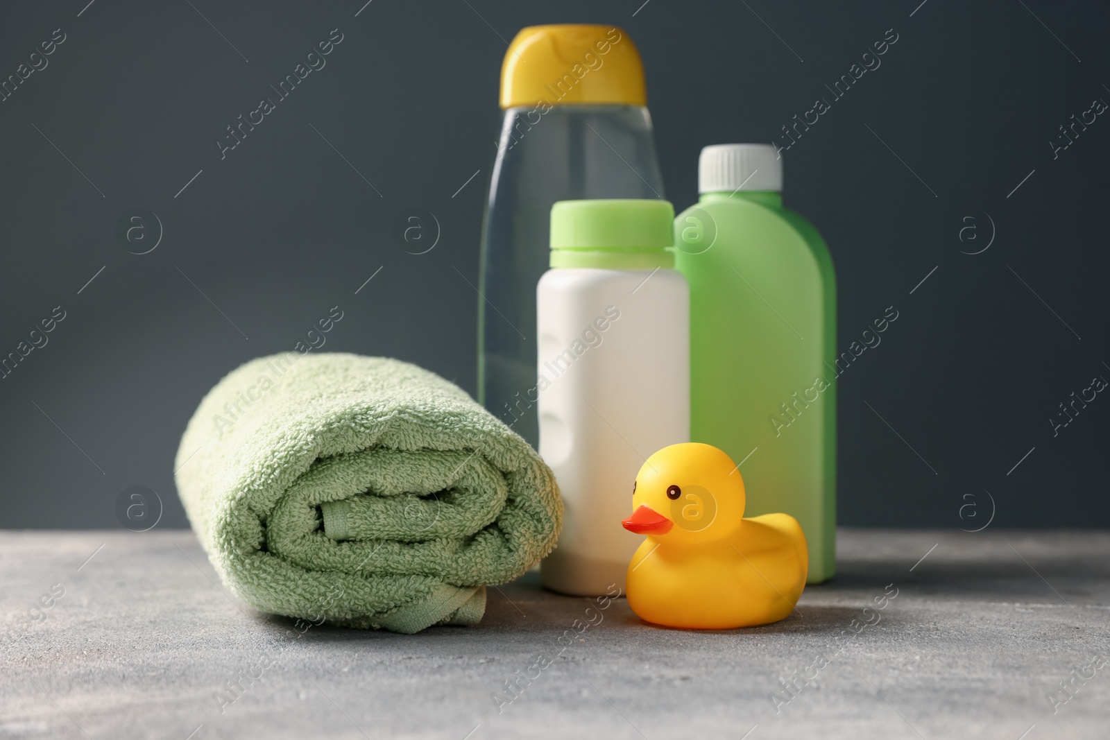 Photo of Baby bath accessories and care products on grey table