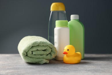 Photo of Baby bath accessories and care products on grey table