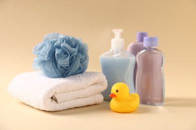 Photo of Baby bath accessories and care products on beige background