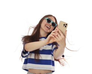 Photo of Happy woman in sunglasses with beautiful long hair using smartphone on white background