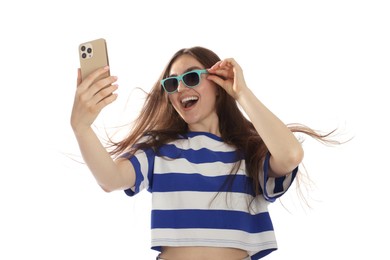 Photo of Happy woman in sunglasses with beautiful long hair using smartphone on white background