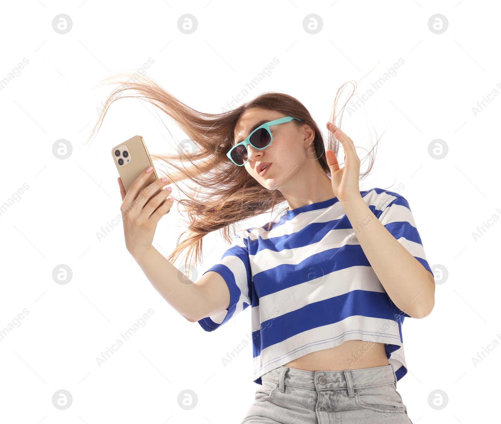 Photo of Woman in sunglasses with beautiful long hair using smartphone on white background, low angle view