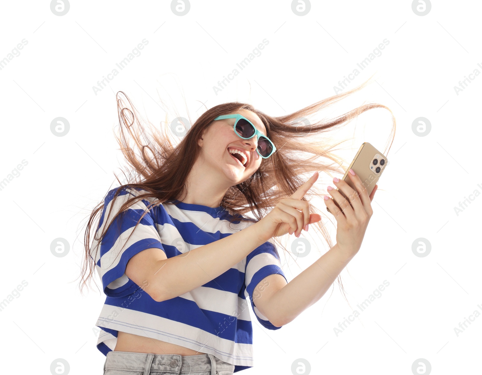 Photo of Happy woman in sunglasses with beautiful long hair using smartphone on white background, low angle view