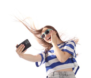 Photo of Happy woman in sunglasses with beautiful long hair using smartphone on white background, low angle view