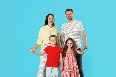 Photo of Portrait of happy family on light blue background