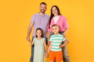 Photo of Portrait of happy family on yellow background
