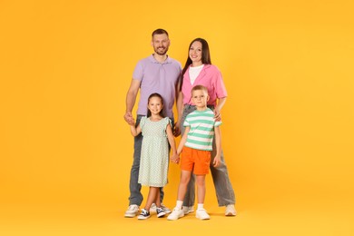 Photo of Lovely family posing together on yellow background