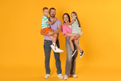 Photo of Lovely family posing together on yellow background