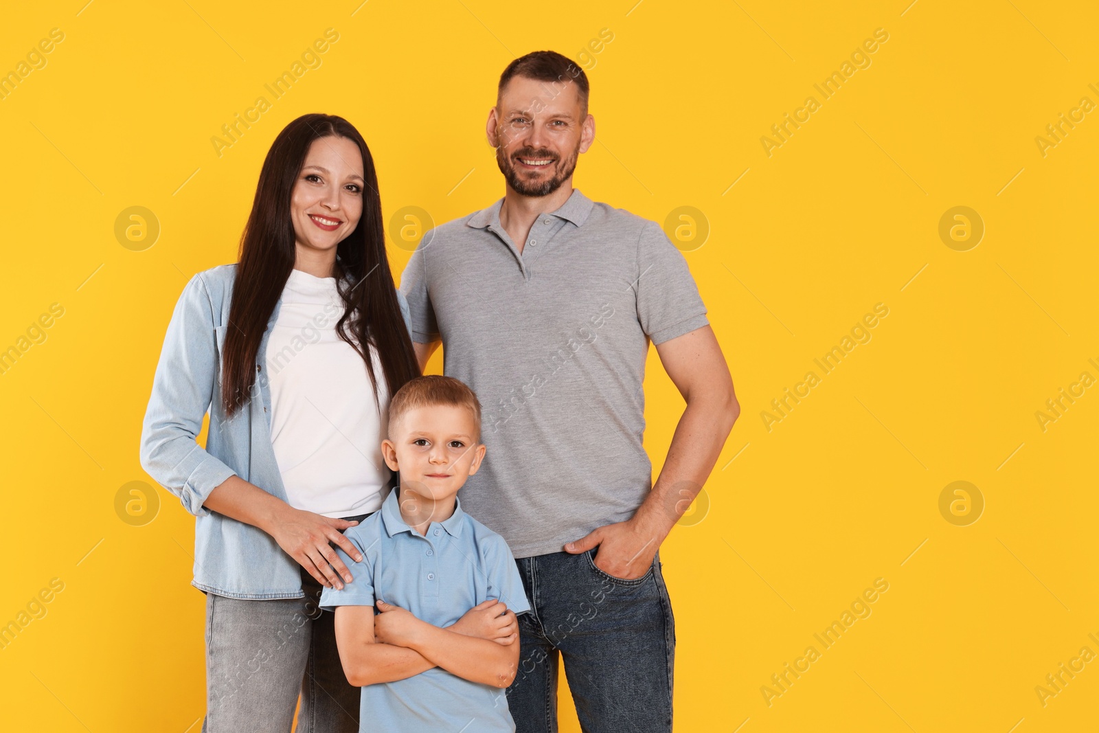 Photo of Portrait of happy family on yellow background. Space for text