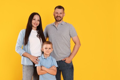 Photo of Portrait of happy family on yellow background. Space for text