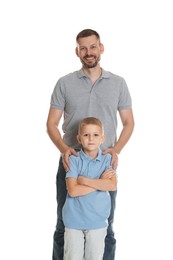 Photo of Father and son posing together on white background