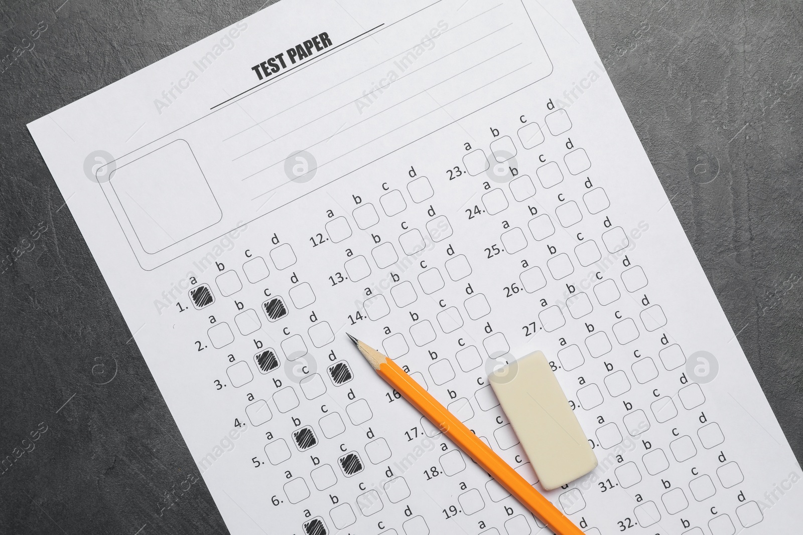 Answer sheet, pencil and eraser on gray textured table, flat lay. Student passing exam Photo of Answer sheet, pencil and eraser on gray textured table, flat lay. Student passing exam