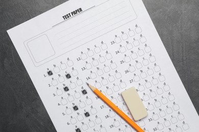 Photo of Answer sheet, pencil and eraser on gray textured table, flat lay. Student passing exam
