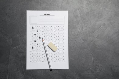 Photo of Student passing exam. Answer sheet, pencil and eraser on gray textured table, flat lay. Space for text