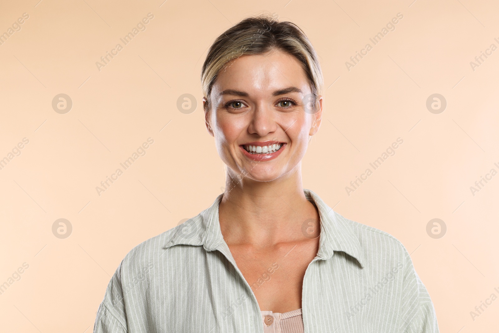 Photo of Woman with beautiful healthy teeth on beige background