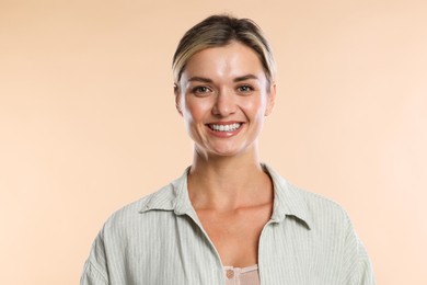 Photo of Woman with beautiful healthy teeth on beige background
